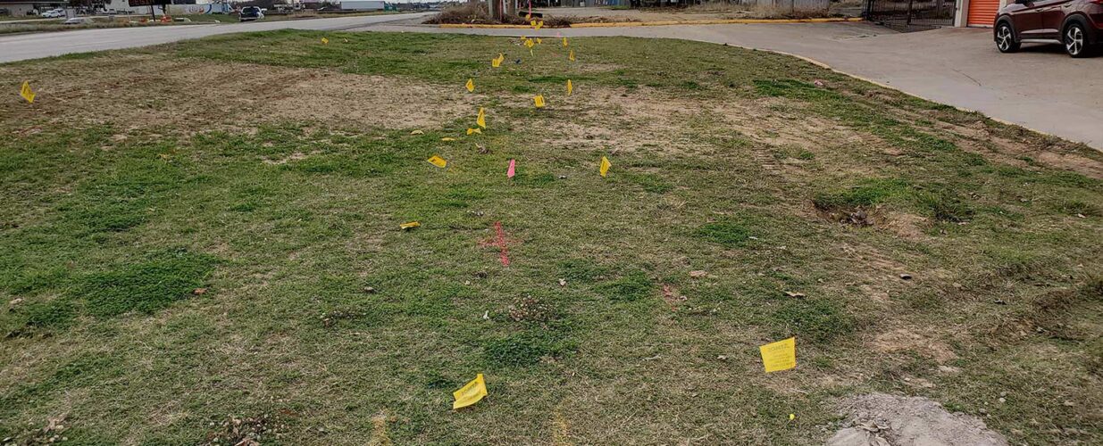 flag markings in the ground for Diamond Interchange right of way project